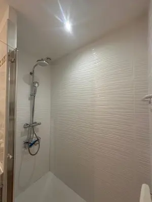 a bathroom with a shower and a glass shower stall at Bastidon de Gordes in Gordes