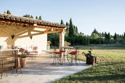 a patio with a table and chairs and a table and chairs at Authentique mas avec vue et piscine Eygalieres LS1-447 in Eygalières
