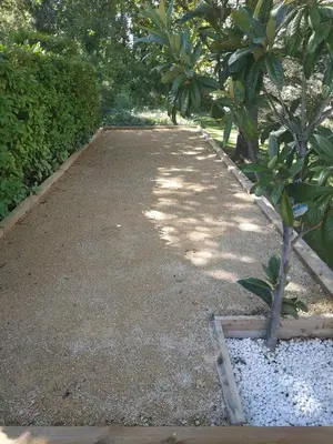a pathway in a garden with a tree and bushes at Au Bonheur et Liberté in Meyrargues