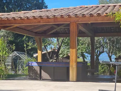 a wooden pergola with a blue bench under it at Au Bonheur et Liberté in Meyrargues