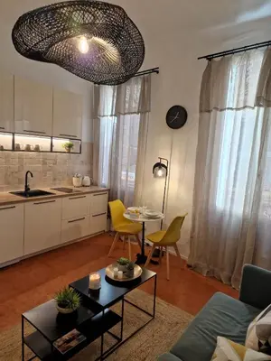 a living room with a couch and a table at Appartement Cosy Hyper Centre Climatisé - Rue Bédarrides in Aix-en-Provence