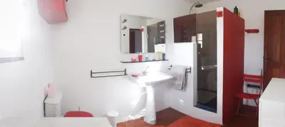 a white bathroom with a sink and a mirror at Mas de Regardebon in Mazan