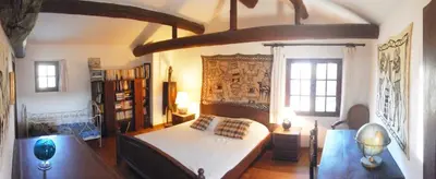 a bedroom with a large bed in a room at Mas de Regardebon in Mazan