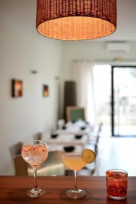 two wine glasses sitting on a wooden table at Hôtel Bellegarde by Viktor in Aix-en-Provence