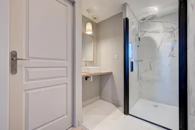 a bathroom with a shower and a glass door at Hôtel Bellegarde by Viktor in Aix-en-Provence
