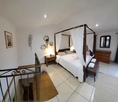 a bedroom with a bed with a canopy at La bonne adresse de Provence in Cornillon-Confoux