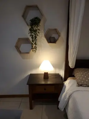 a lamp on a table next to a bed at La bonne adresse de Provence in Cornillon-Confoux