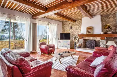 a living room with leather furniture and a fireplace at Villa Cheval Blanc by Villa Plus in Cheval-Blanc
