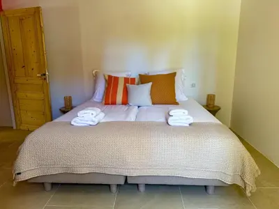a bedroom with a large bed with towels on it at La Magnanerie 1818 villa de prestige 5 étoiles Luberon in Saint-Saturnin-les-Apt