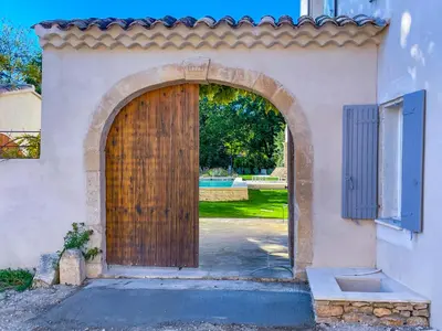an entrance to a house with a wooden door at La Magnanerie 1818 villa de prestige 5 étoiles Luberon in Saint-Saturnin-les-Apt