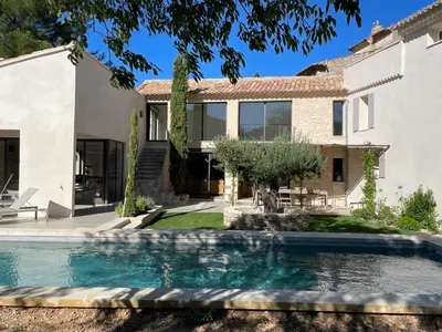 a house with a swimming pool in front of a house at La Magnanerie 1818 villa de prestige 5 étoiles Luberon in Saint-Saturnin-les-Apt