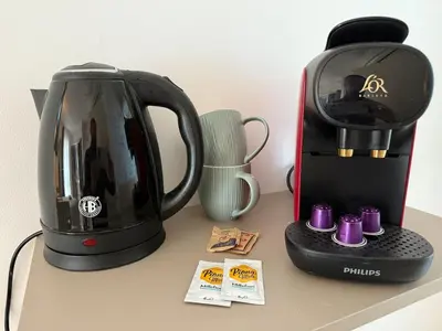 affeepot and a coffee maker on a counter at Le Clos d'Aix studio 105 parking in Aix-en-Provence