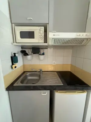 a kitchen with a sink and a microwave at Le Clos d'Aix studio 105 parking in Aix-en-Provence