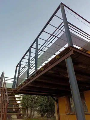 a metal deck on top of a building with stairs at Gîte à la ferme in Sénas