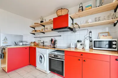 a table with plates and bowls of food on it at EDEN l Jardin, Bbq, Duplex l Parking Gratuit & Super Wifi l Vue Panoramique Sainte-Victoire in Aix-en-Provence