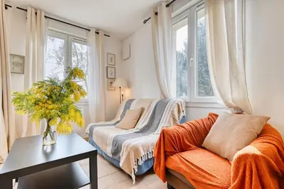 a living room with a couch and a bed at EDEN l Jardin, Bbq, Duplex l Parking Gratuit & Super Wifi l Vue Panoramique Sainte-Victoire in Aix-en-Provence
