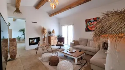 a living room with a couch and a table at La Balinaise in Apt