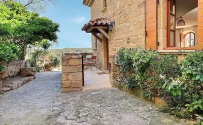 an entrance to a stone house with an archway at Noceta in Miramas