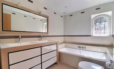 a bathroom with a tub and a sink and a mirror at Noceta in Miramas