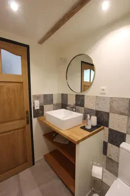a bathroom with a sink and a mirror at La ferme du Loup in Cucuron