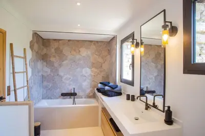 a bathroom with a white tub and a sink and a bath tubermott at 8-bedroom luxury villa with pool in Gordes