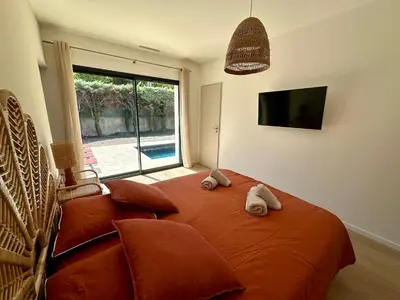 a bedroom with a large orange bed with two pillows at Villa Provençale in Le Thor