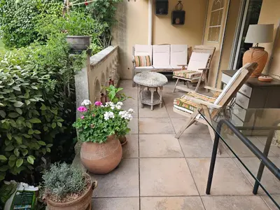 a patio with some plants and chairs and flowers at Aix centre, 2 room apartment garden, parking in Aix-en-Provence