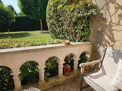 a stone wall with a bench and a plant at Aix centre, 2 room apartment garden, parking in Aix-en-Provence