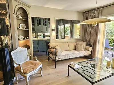 a living room with a couch and a glass table at Aix centre, 2 room apartment garden, parking in Aix-en-Provence