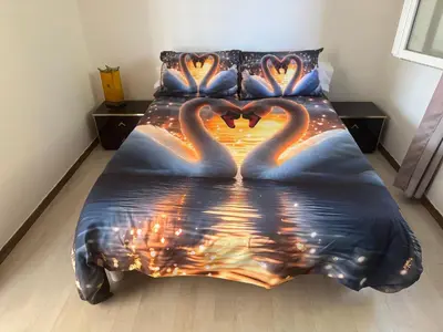 a bed with two swans making a heart at Maison provençale de charme in Velaux