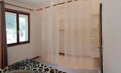 a bedroom with a shower with a bed and a window at Maison provençale de charme in Velaux