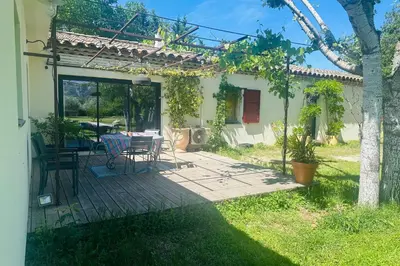 a patio with a table and chairs in a yard at House with heated swimming pool and breathtaking views of the Luberon in Robion en Luberon