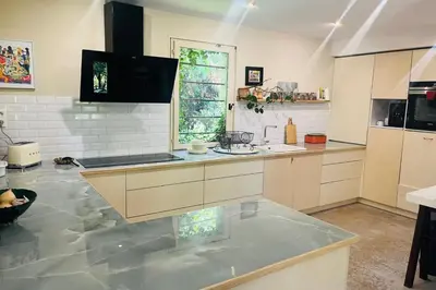 a large kitchen with a large counter top in a room at House with heated swimming pool and breathtaking views of the Luberon in Robion en Luberon