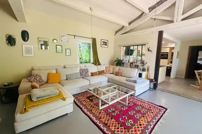 a living room with a couch and a table at House with heated swimming pool and breathtaking views of the Luberon in Robion en Luberon