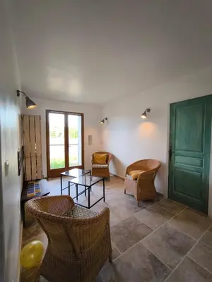 a living room with two chairs and a table at Le Mas des iscles Mallemort in Mallemort