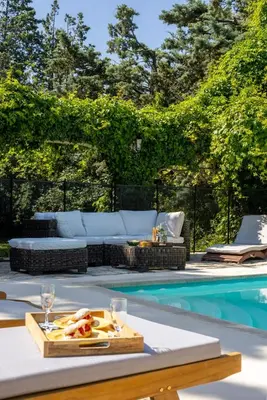 a table with a tray of food next to a swimming pool at Mas des Olivades - Ferme Provençale - Piscine in Pernes-les-Fontaines
