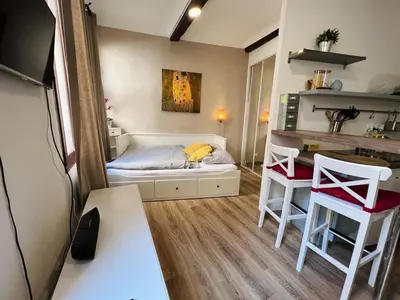 a small room with a bed and a desk at Bel Appartement dans le centre d'Aix-en-Provence in Aix-en-Provence