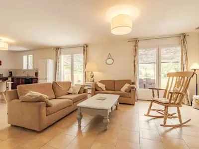 a living room with a couch and a table at Gîte en Provence entre Pernes les fontaines et St Didier proche l'isle sur sorgues face Mont Ventoux Villa avec piscine in Saint-Didier