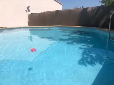 a pool of blue water with a red ball in it at Gîte en Provence entre Pernes les fontaines et St Didier proche l'isle sur sorgues face Mont Ventoux Villa avec piscine in Saint-Didier