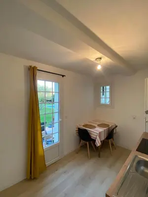 a dining room with a table and a window at Studio en Provence avec piscine in La Barben
