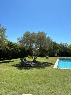 a couple of chairs sitting next to a swimming pool at Studio en Provence avec piscine in La Barben