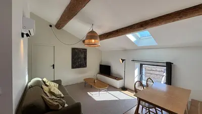 a living room with a couch and a table at Le Granier location in Robion en Luberon