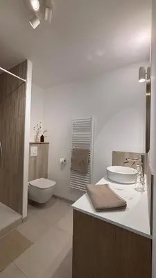a white bathroom with a toilet and a sink at Le Granier location in Robion en Luberon