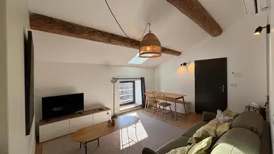 a living room with a couch and a table at Le Granier location in Robion en Luberon