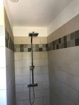a shower with a shower head in a bathroom at Petite maison au calme avec piscine privative in Saint-Rémy-de-Provence