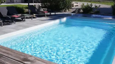 a white house with chairs and tables in front of it at Domaine du Piol - Luberon - Piscine privée - Clim - Beach Volley in Mazan