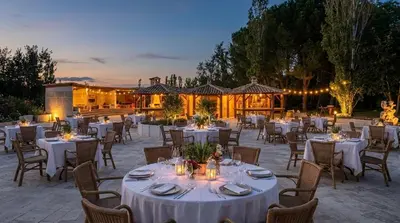 an outdoor dining area with tables and chairs at Domaine de la Myrtille in Pertuis
