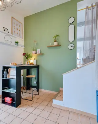 a book shelf with a lamp and a book at MAYA l Studio l Super Wifi & Parking Gratuit l Vue Panoramique Sainte-Victoire in Aix-en-Provence