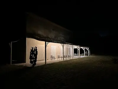 a building lit up in the dark at night at les Claveaux in Montfuron