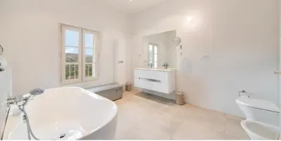 a bathroom with a tub and a sink and a toilet at les Claveaux in Montfuron